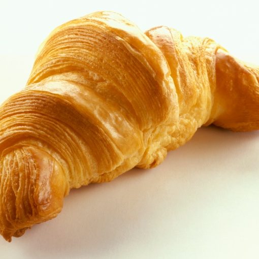 A baked croissant on a white surface